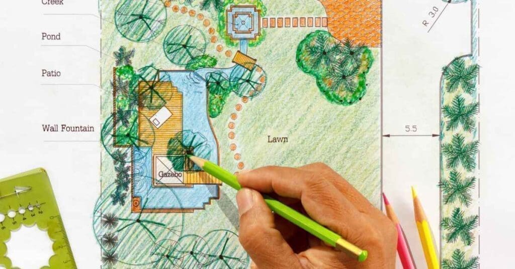 Picture of a person drawing a garden design including water features and plants.